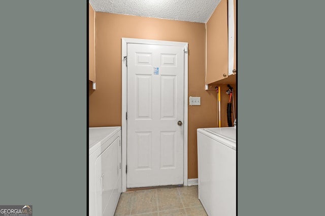 laundry area featuring cabinets, a textured ceiling, and independent washer and dryer