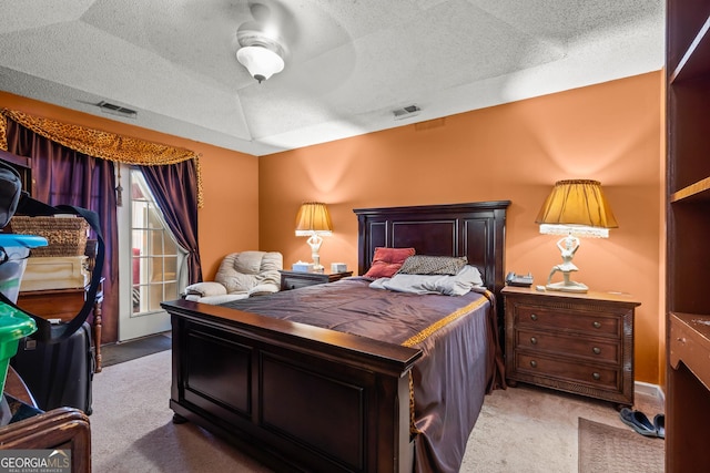 carpeted bedroom with ceiling fan, access to exterior, and a textured ceiling