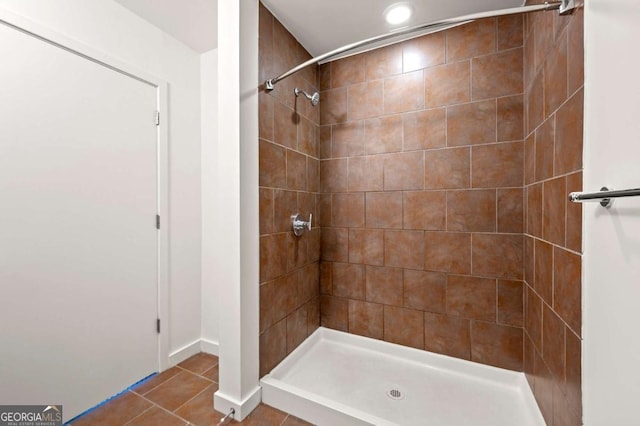 bathroom with tile patterned floors and a tile shower