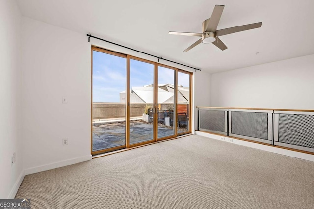 carpeted spare room featuring ceiling fan