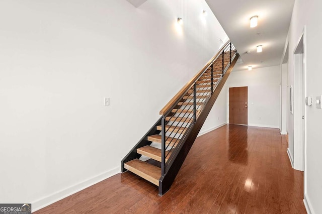 stairway with hardwood / wood-style floors