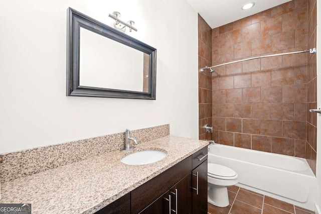 full bathroom with tiled shower / bath, vanity, toilet, and tile patterned flooring