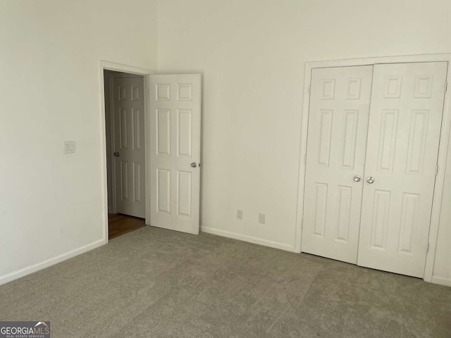 unfurnished bedroom with carpet floors and a closet