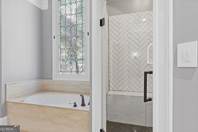 bathroom with tile patterned flooring, a bathing tub, and ornamental molding