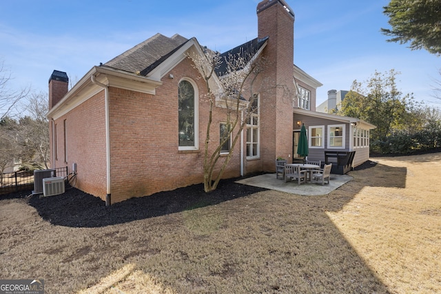 back of house featuring a yard, a patio, and central air condition unit