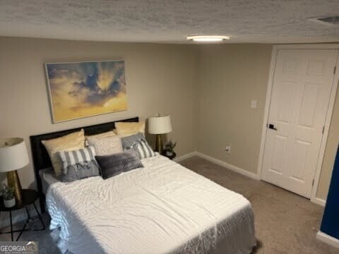 carpeted bedroom with a textured ceiling