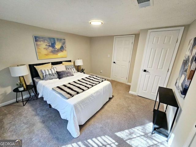 carpeted bedroom with a textured ceiling