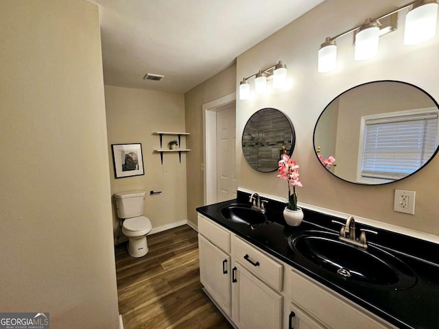 bathroom featuring vanity, hardwood / wood-style flooring, and toilet