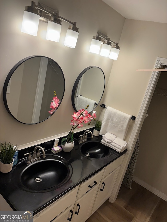 bathroom featuring vanity and hardwood / wood-style floors