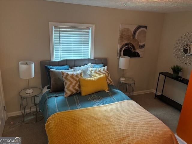 bedroom featuring dark carpet and a textured ceiling