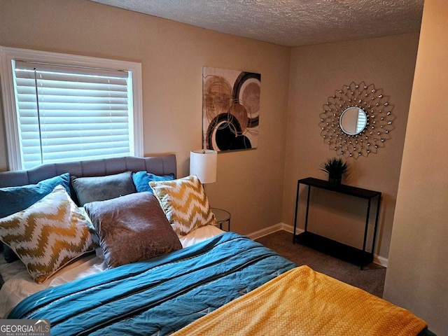 carpeted bedroom with a textured ceiling