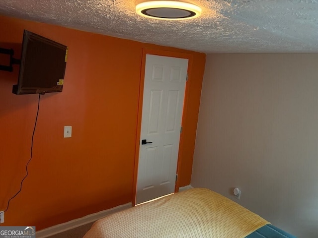 unfurnished bedroom featuring carpet floors and a textured ceiling