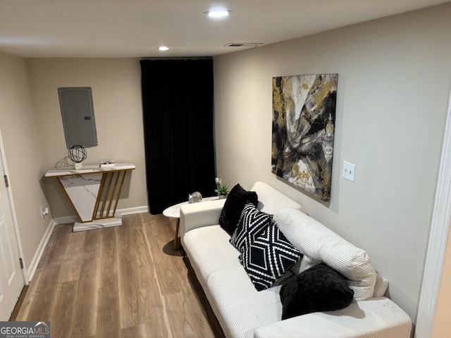 living room featuring hardwood / wood-style flooring and electric panel