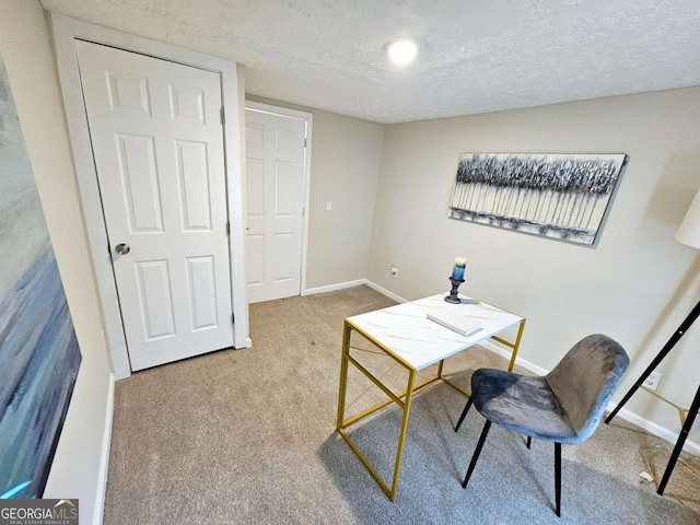 carpeted home office with a textured ceiling