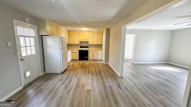 kitchen with range with electric stovetop, light hardwood / wood-style floors, a textured ceiling, and white refrigerator