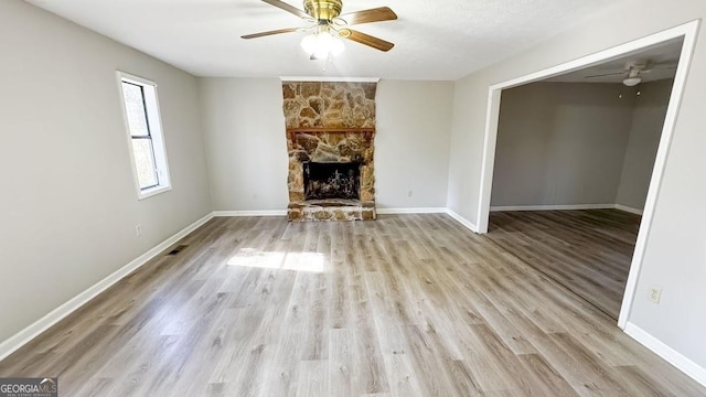 unfurnished living room featuring baseboards, a ceiling fan, and wood finished floors