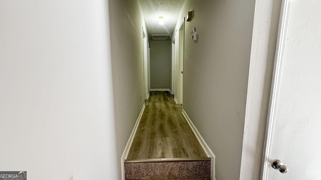 corridor with a textured ceiling