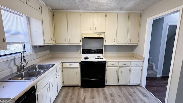 kitchen featuring a textured ceiling, under cabinet range hood, black dishwasher, a sink, and electric range
