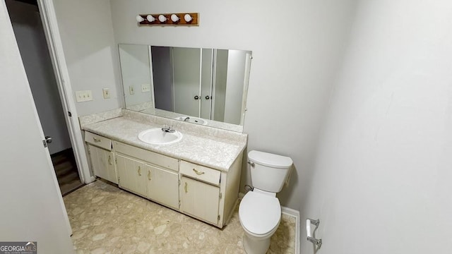 half bathroom with toilet and vanity