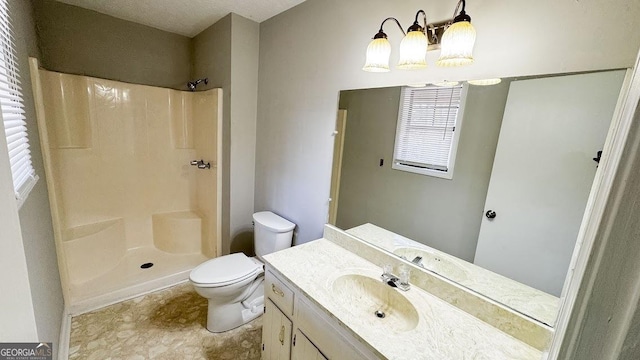 full bath featuring an inviting chandelier, toilet, a shower, and vanity