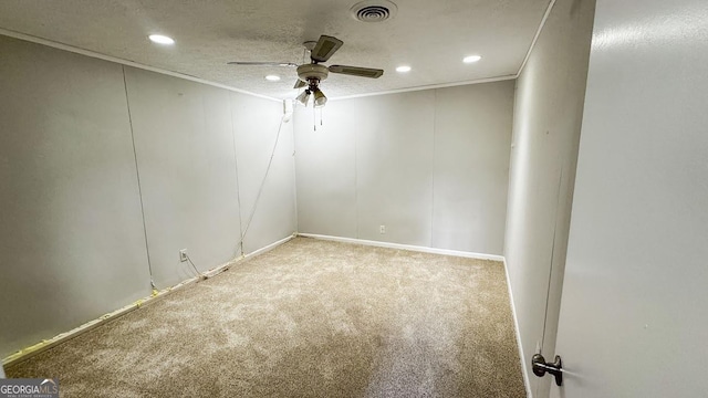 empty room with crown molding, carpet flooring, a textured ceiling, and ceiling fan