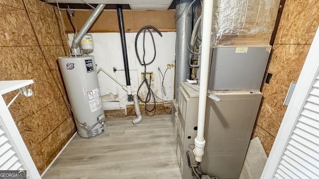 utility room featuring water heater and heating unit