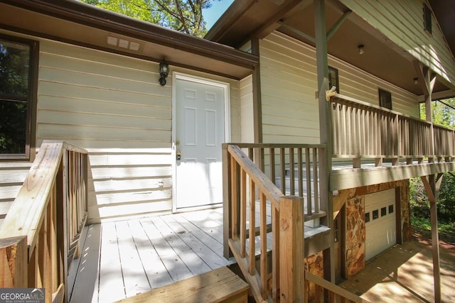 wooden deck featuring a garage