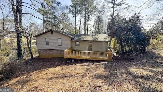 back of property featuring a wooden deck