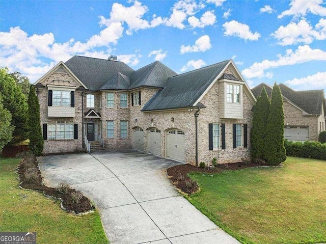 view of front of property featuring a garage and a front lawn