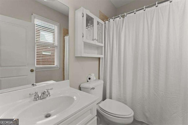 bathroom featuring vanity and toilet