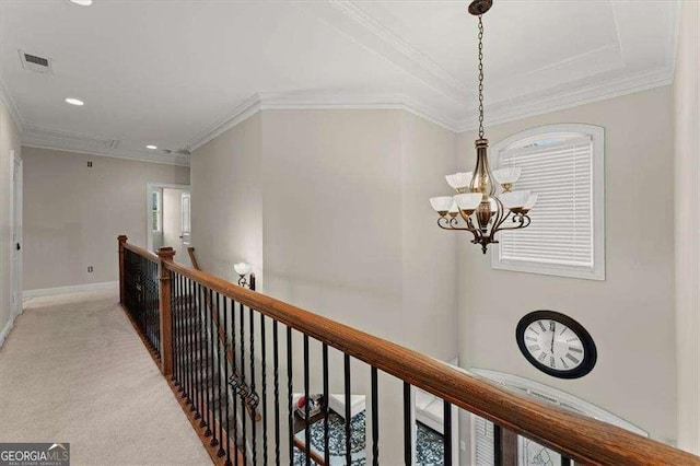 corridor featuring an inviting chandelier, crown molding, and light carpet