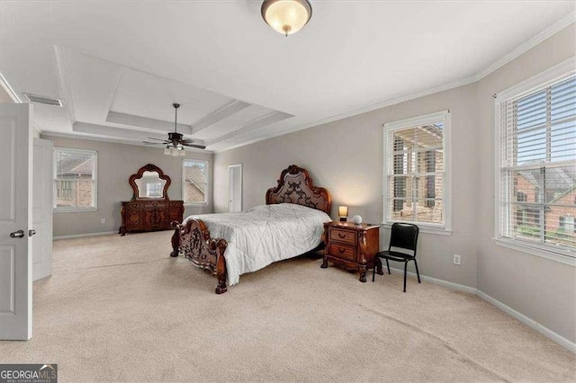 bedroom featuring crown molding, light colored carpet, a raised ceiling, and multiple windows