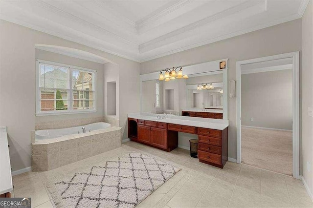 bathroom featuring tile patterned flooring, vanity, ornamental molding, a relaxing tiled tub, and a raised ceiling