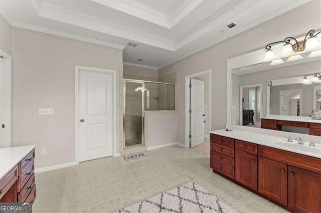 bathroom featuring crown molding, vanity, a tray ceiling, and a shower with shower door