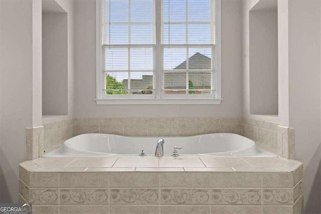 bathroom with tiled bath