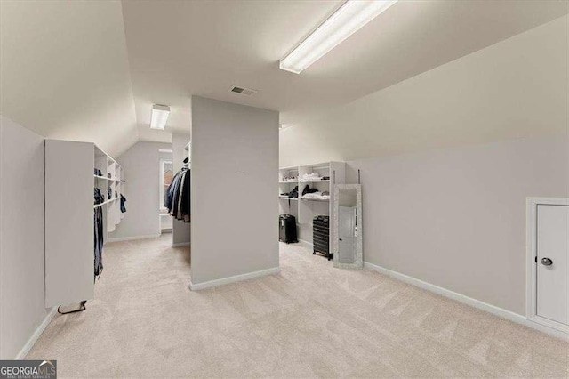 bonus room featuring vaulted ceiling and light colored carpet