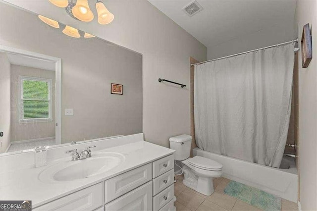 full bathroom with vanity, tile patterned floors, shower / bath combination with curtain, and toilet