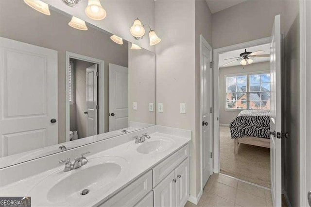 bathroom featuring ceiling fan, vanity, toilet, and tile patterned flooring