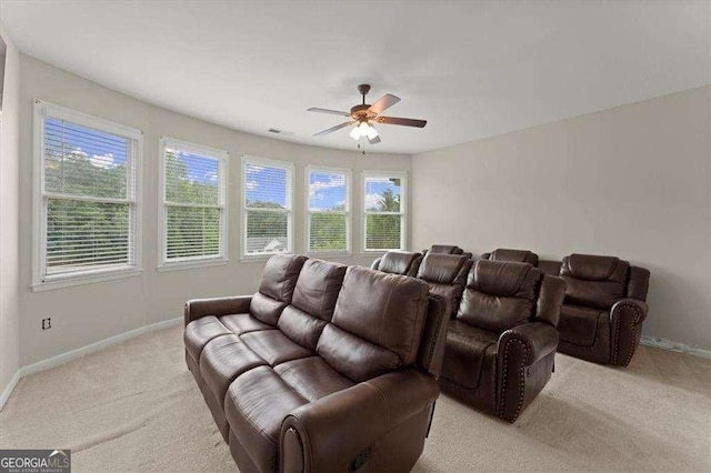 cinema room with light carpet and ceiling fan