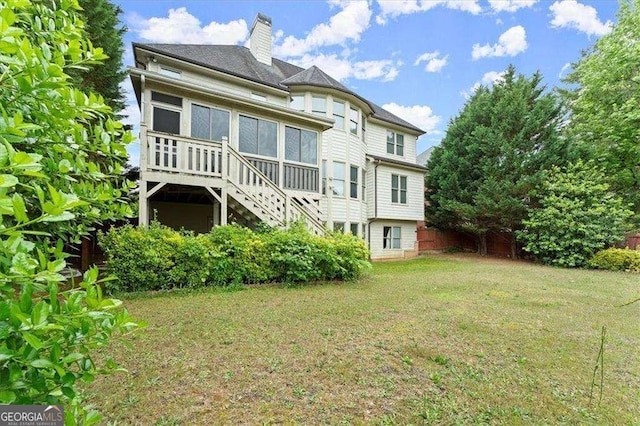 rear view of property with a yard