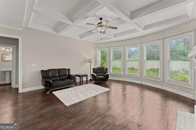 living area featuring beamed ceiling, ceiling fan, dark hardwood / wood-style flooring, and a wealth of natural light