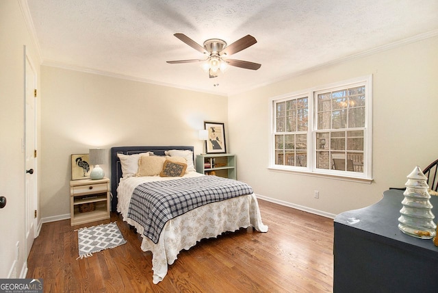 bedroom with wood-type flooring, crown molding, and a textured ceiling