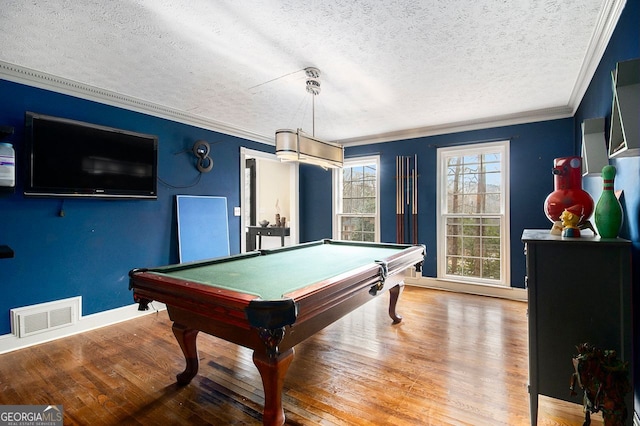 recreation room featuring crown molding, pool table, wood-type flooring, and a textured ceiling