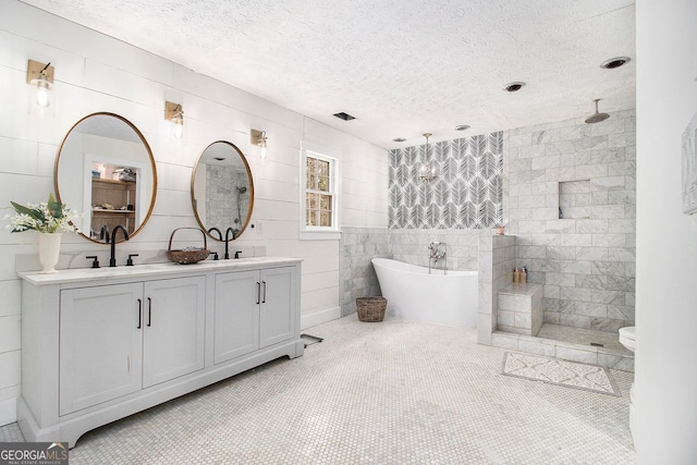 full bathroom featuring vanity, tile patterned floors, a textured ceiling, and separate shower and tub