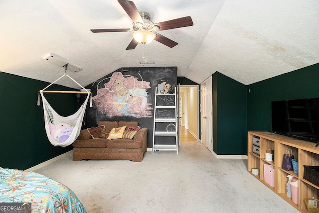 bedroom featuring vaulted ceiling, light carpet, and a textured ceiling