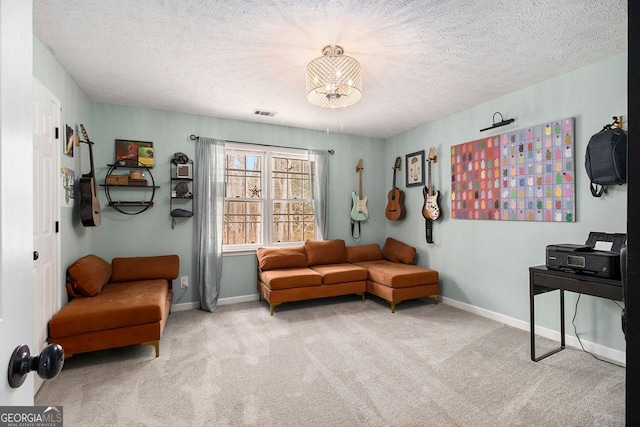 living area with light colored carpet and a textured ceiling