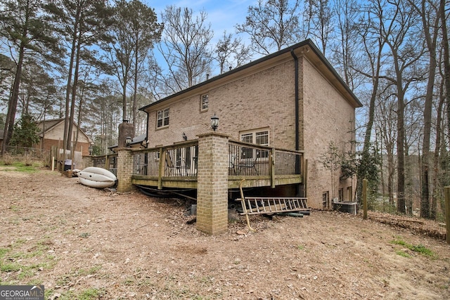 back of house with a deck