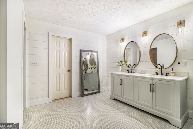 bathroom with vanity and a textured ceiling