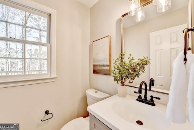 bathroom with vanity, plenty of natural light, and toilet