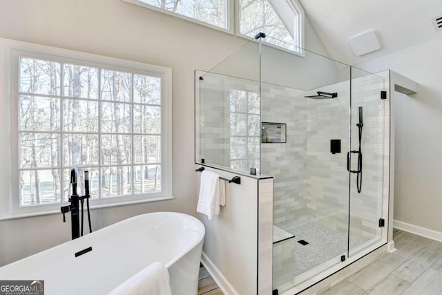 bathroom featuring independent shower and bath, lofted ceiling, and hardwood / wood-style flooring